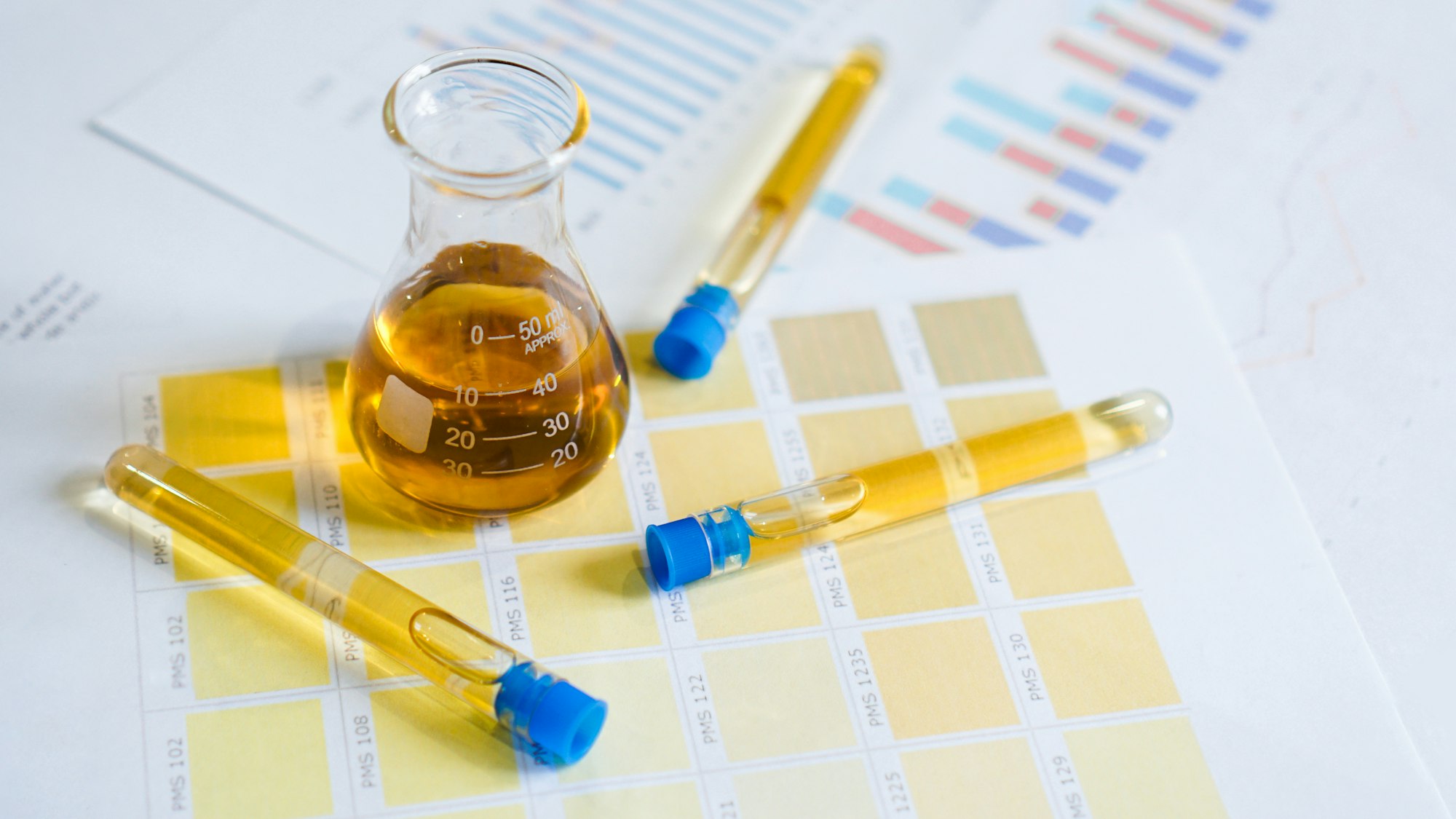 Flask and test tubes with urine on medical color schemes. Concept of analyzes